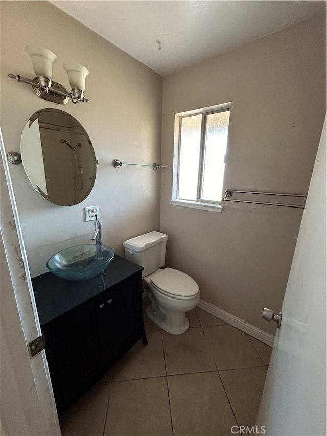 bathroom featuring toilet, vanity, and tile patterned floors