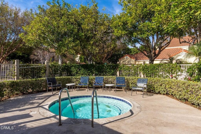 view of pool with a hot tub and a patio