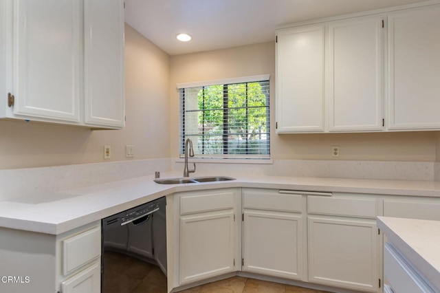 kitchen with light tile patterned floors, black dishwasher, white cabinetry, and sink