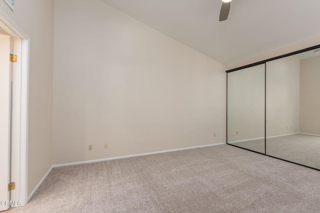 unfurnished bedroom with ceiling fan, a closet, and light carpet