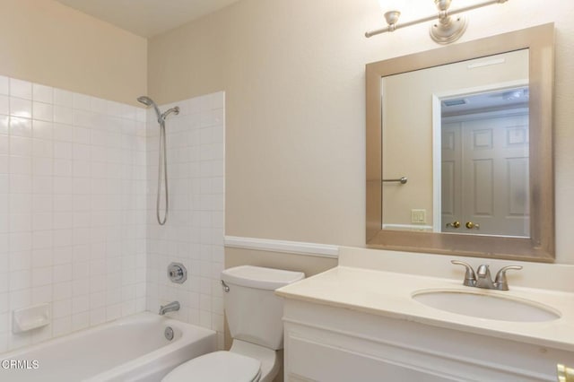 full bathroom with toilet, vanity, and tiled shower / bath