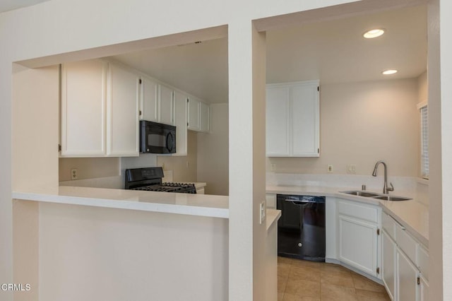 kitchen with sink, white cabinetry, black appliances, and light tile patterned flooring