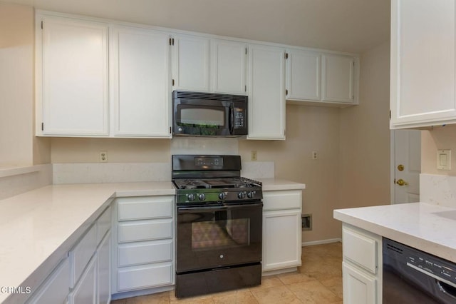 kitchen featuring black appliances, light tile patterned floors, and white cabinetry