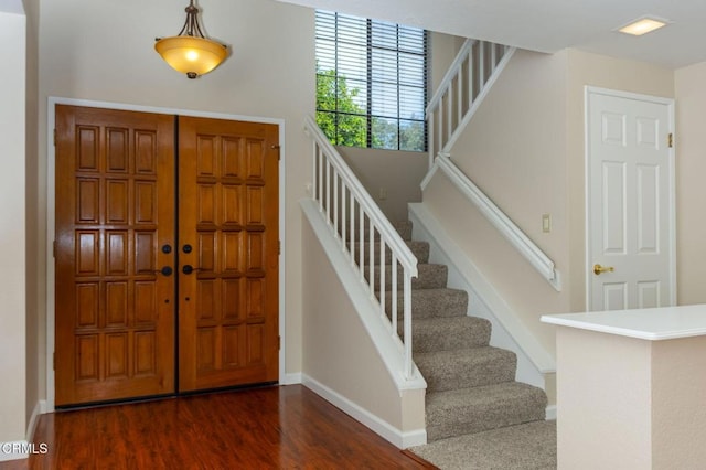 foyer entrance with dark hardwood / wood-style floors