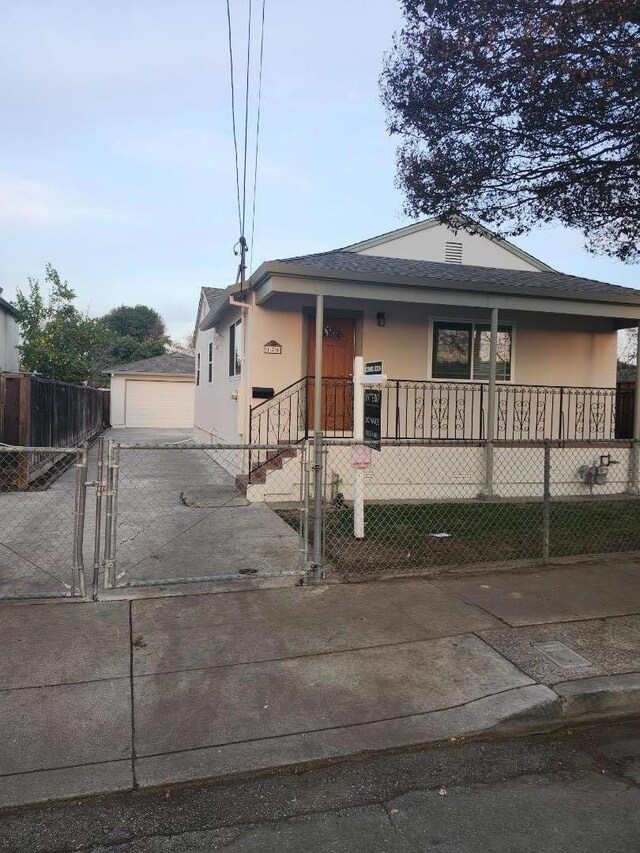 view of front of property with a porch, an outdoor structure, and a garage