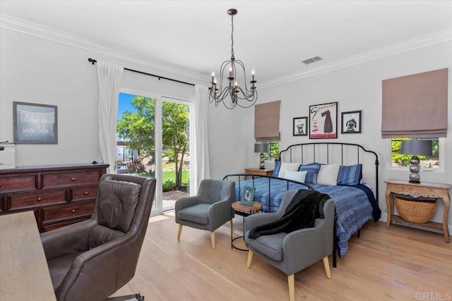 bedroom featuring light hardwood / wood-style floors, access to exterior, crown molding, and an inviting chandelier