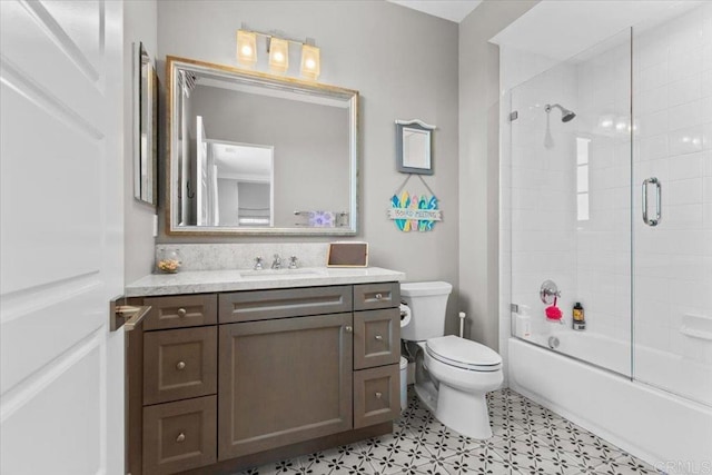 full bathroom with toilet, vanity, and combined bath / shower with glass door