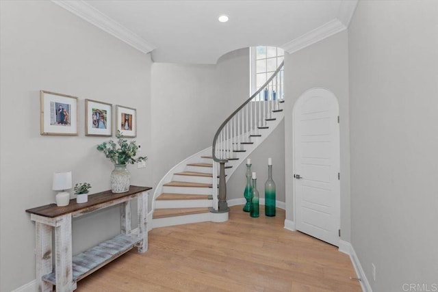 stairway featuring crown molding and wood-type flooring