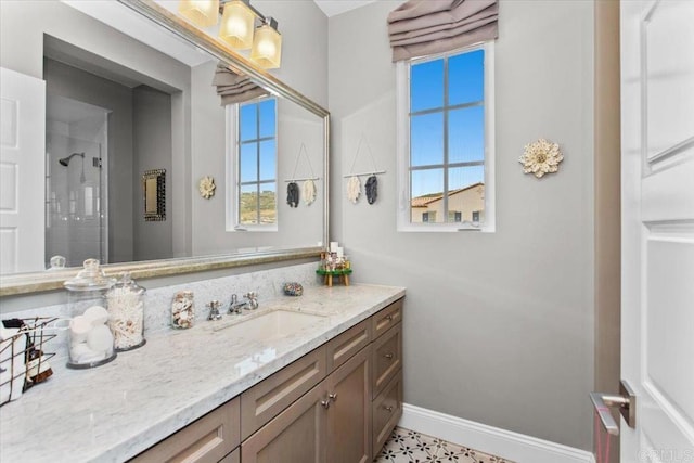 bathroom featuring vanity, a shower, and a wealth of natural light