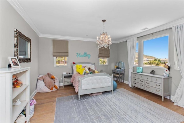 bedroom featuring a notable chandelier, crown molding, multiple windows, and light hardwood / wood-style floors