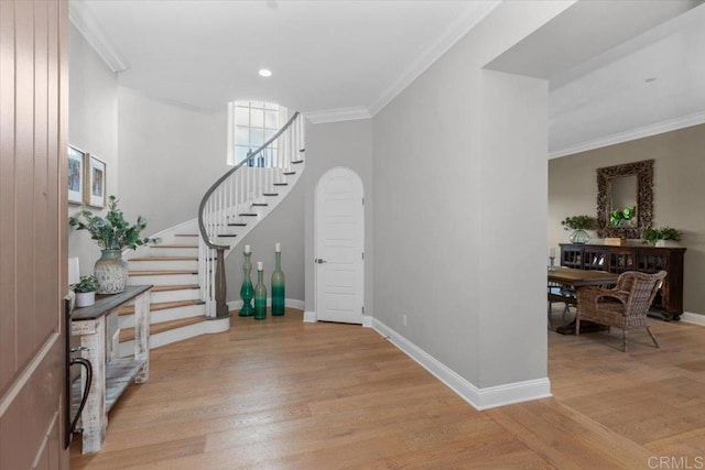 entrance foyer featuring light hardwood / wood-style flooring and crown molding