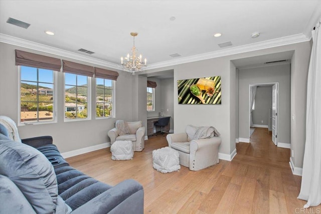 living room with an inviting chandelier, ornamental molding, and hardwood / wood-style flooring