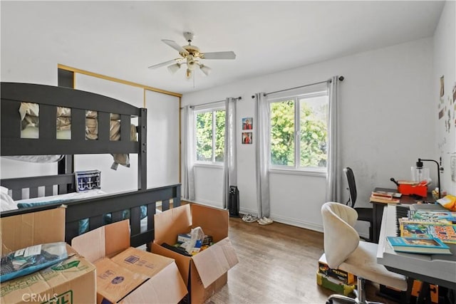 bedroom with ceiling fan and wood-type flooring