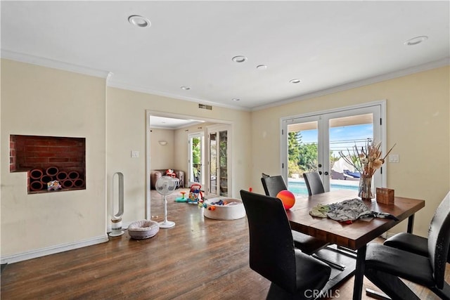 dining area featuring hardwood / wood-style floors, crown molding, and french doors