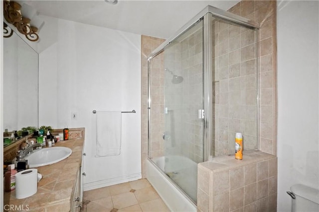 bathroom featuring bath / shower combo with glass door, vanity, and tile patterned flooring