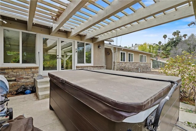 view of patio featuring french doors, a pergola, and a hot tub