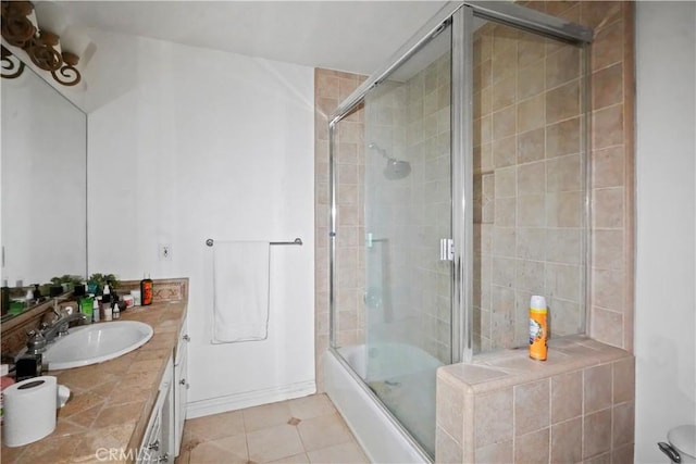 bathroom featuring tile patterned floors, vanity, and shower / bath combination with glass door