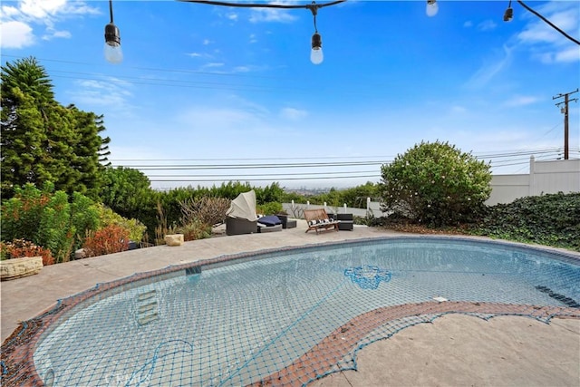 view of pool with an outdoor living space and a patio area