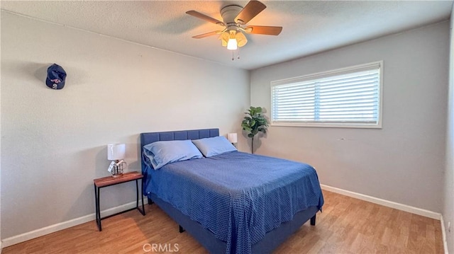 bedroom featuring ceiling fan, a textured ceiling, and hardwood / wood-style flooring