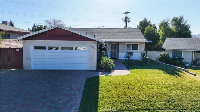 ranch-style home with a front lawn and a garage