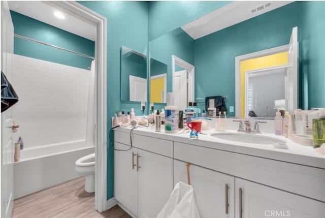 full bathroom featuring toilet, vanity, and shower / bathtub combination with curtain