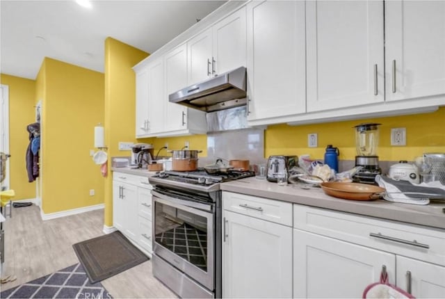 kitchen with white cabinetry, stainless steel range with gas stovetop, and light wood-type flooring