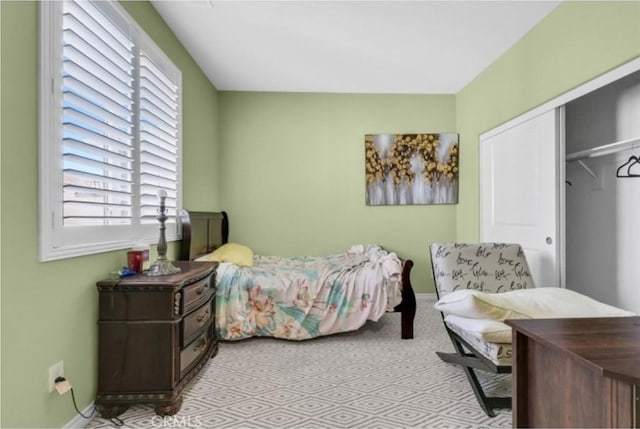 bedroom with multiple windows and a closet