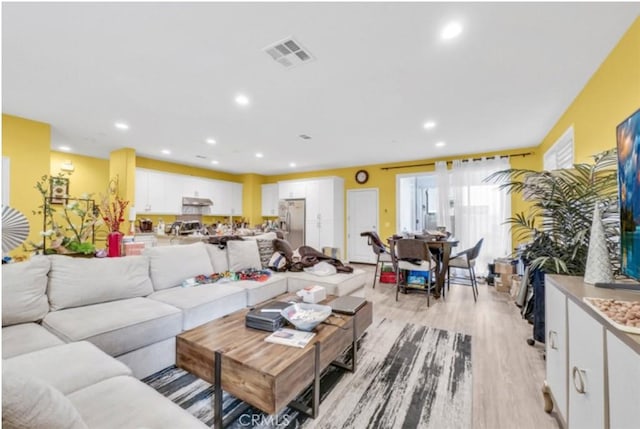 living room with light hardwood / wood-style flooring