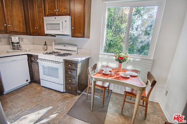 kitchen featuring a wealth of natural light and white appliances