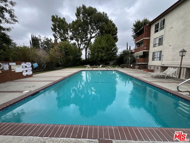 view of swimming pool with a patio area