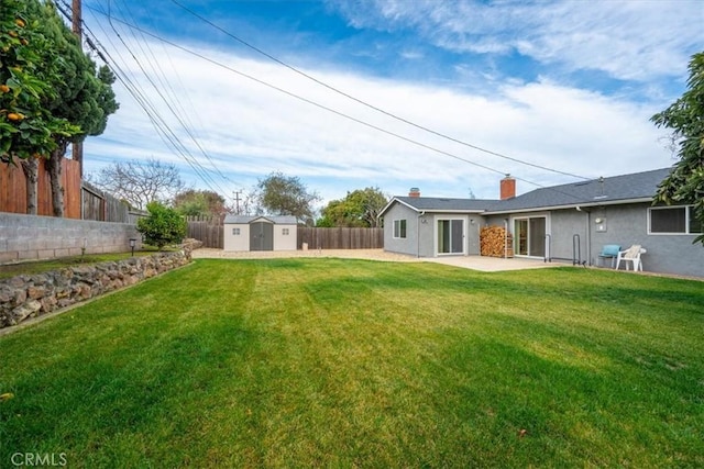 view of yard featuring a patio area and a storage unit