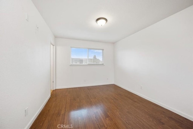 empty room with hardwood / wood-style flooring