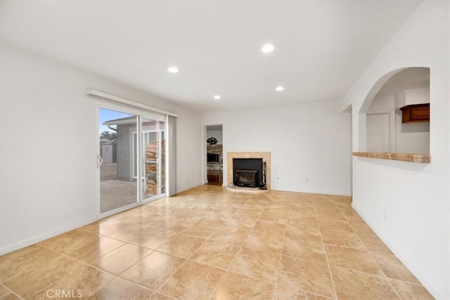 unfurnished living room featuring a wood stove