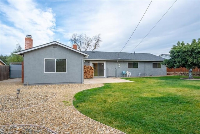 rear view of property featuring a lawn and a patio