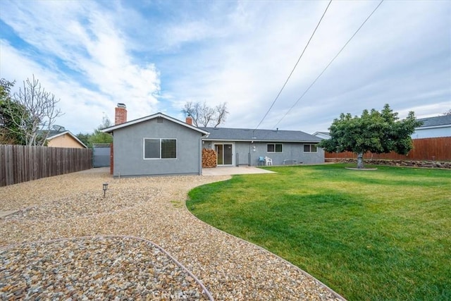 back of house with a patio area and a yard