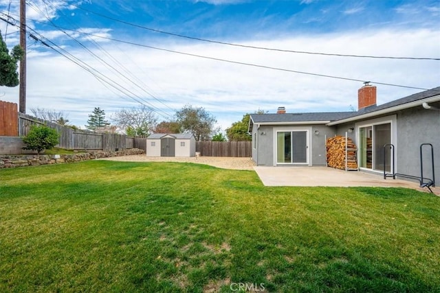 view of yard featuring a shed and a patio