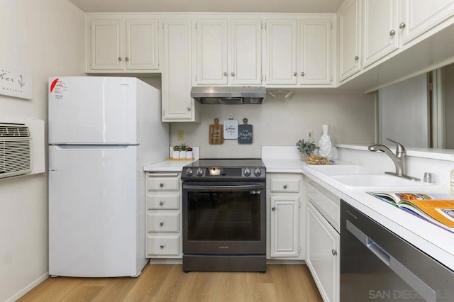 kitchen featuring white refrigerator, dishwasher, white cabinets, and electric range