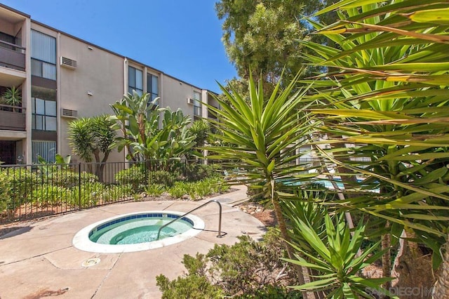 view of swimming pool featuring a hot tub