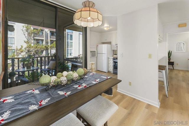 dining space featuring light wood-type flooring