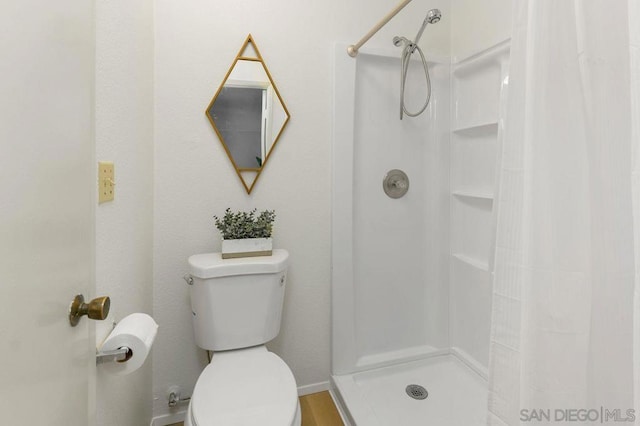 bathroom with toilet and a shower