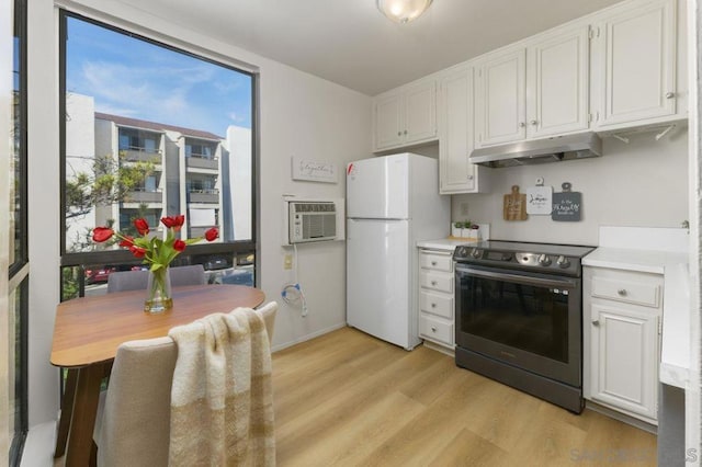 kitchen with stainless steel range with electric cooktop, white refrigerator, white cabinetry, and light hardwood / wood-style flooring