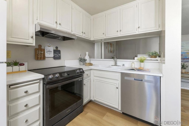 kitchen with stainless steel dishwasher, electric range, white cabinetry, and light hardwood / wood-style floors