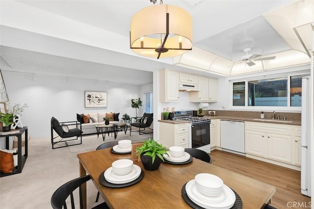 kitchen featuring sink, dishwasher, ceiling fan, white cabinets, and gas range