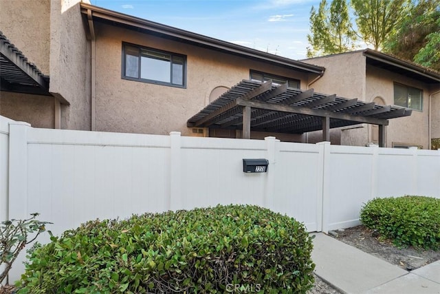 view of property exterior with a pergola