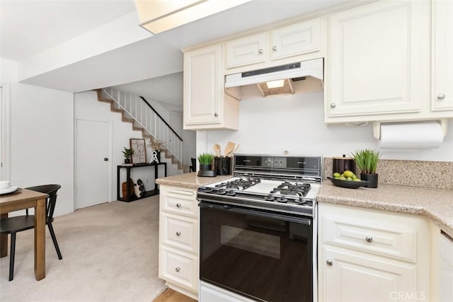 kitchen with light colored carpet and gas stove