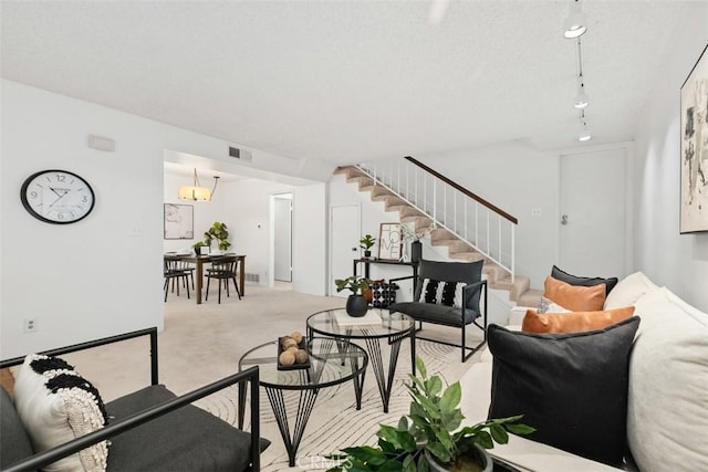 carpeted living room featuring rail lighting