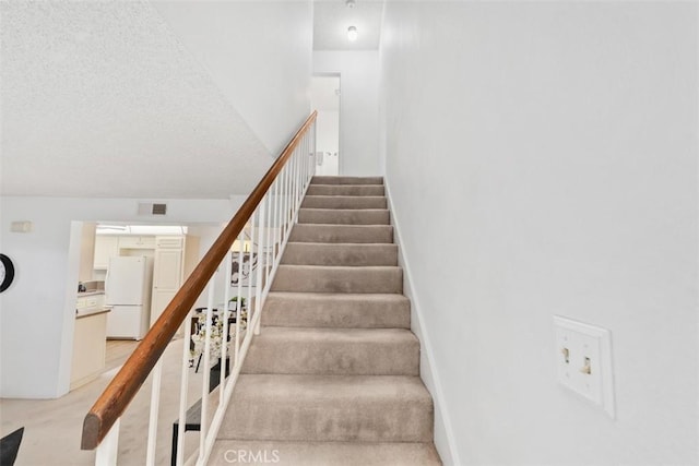 staircase with hardwood / wood-style flooring