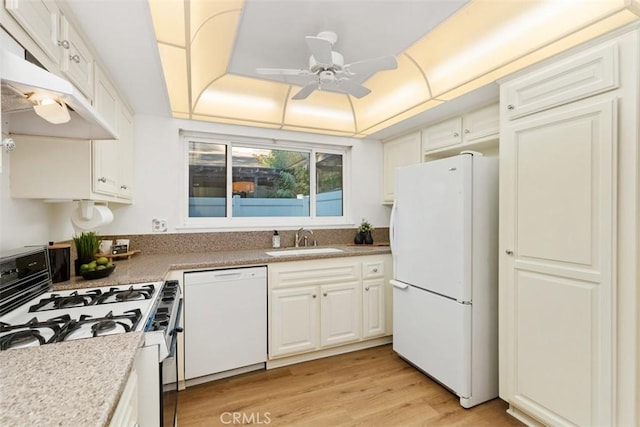 kitchen with sink, white appliances, light hardwood / wood-style flooring, white cabinets, and a raised ceiling