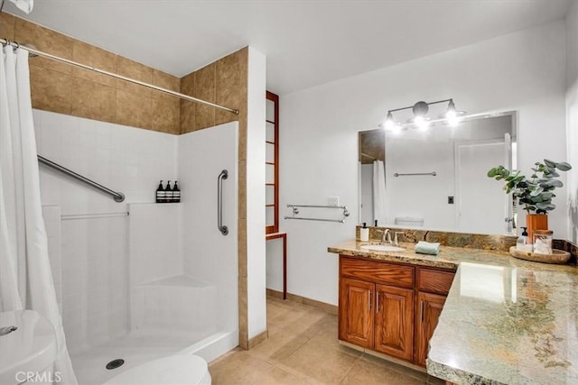 bathroom with toilet, vanity, a shower with curtain, and tile patterned flooring