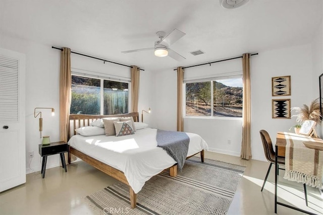 bedroom with ceiling fan and multiple windows